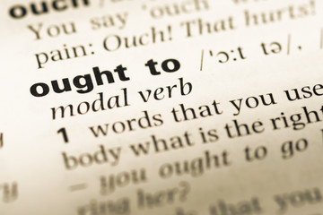 Fototapeta premium Close up of old English dictionary page with word ought to