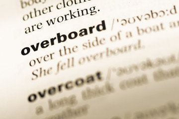 Close up of old English dictionary page with word overboard