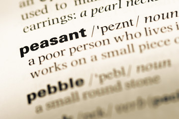 Close up of old English dictionary page with word peasant