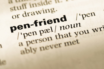 Obraz premium Close up of old English dictionary page with word pen friend