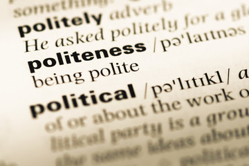 Close up of old English dictionary page with word politeness