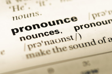 Close up of old English dictionary page with word pronounce