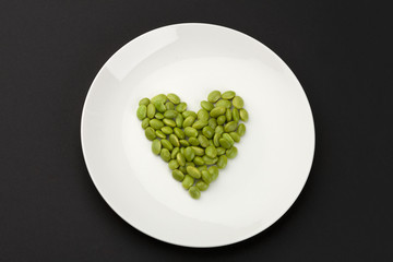 green soya beans arranged in heart shape.
