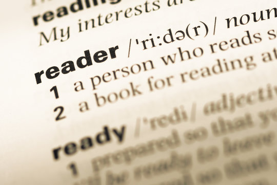 Close up of old English dictionary page with word reader