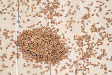 Flax seeds on wooden background