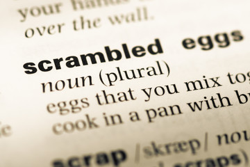 Obraz premium Close up of old English dictionary page with word scrambled egg