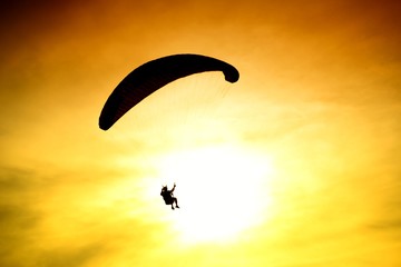 Silhouette of parachute on sunset