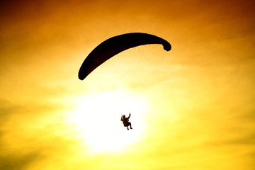 Silhouette of parachute on sunset