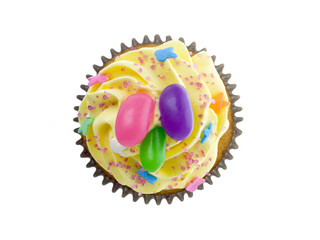 cupcake with yellow icing with candy beans
