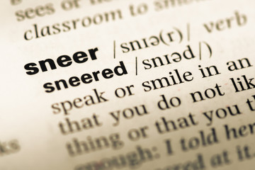 Fototapeta premium Close up of old English dictionary page with word sneer