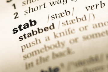 Close up of old English dictionary page with word stab