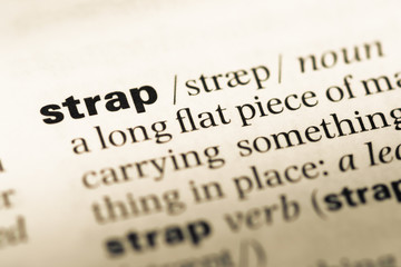Fototapeta premium Close up of old English dictionary page with word strap
