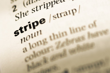 Close up of old English dictionary page with word stripe