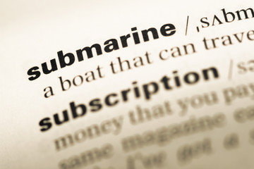 Close up of old English dictionary page with word submarine