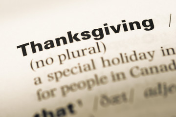 Close up of old English dictionary page with word thanksgiving