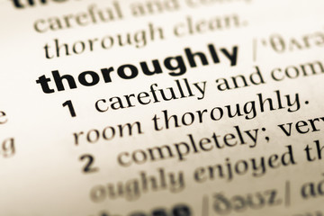 Obraz premium Close up of old English dictionary page with word thoroughly