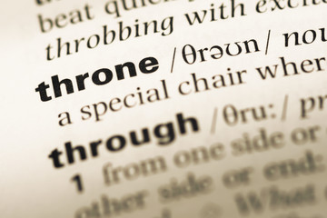 Close up of old English dictionary page with word throne