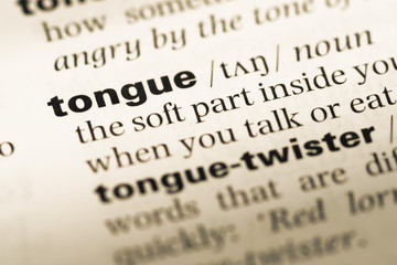 Fototapeta premium Close up of old English dictionary page with word tongue