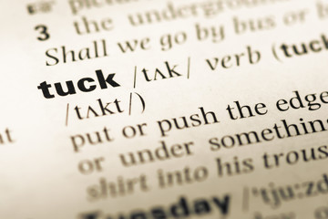 Close up of old English dictionary page with word tuck