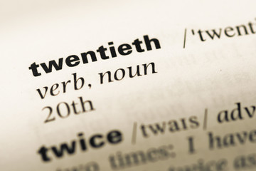 Close up of old English dictionary page with word twentieth