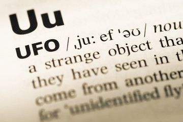 Obraz premium Close up of old English dictionary page with word ufo