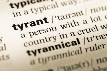 Obraz premium Close up of old English dictionary page with word tyrant