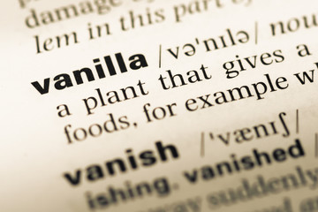 Obraz premium Close up of old English dictionary page with word vanilla