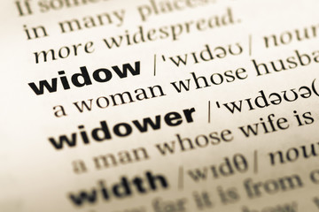 Fototapeta premium Close up of old English dictionary page with word widow