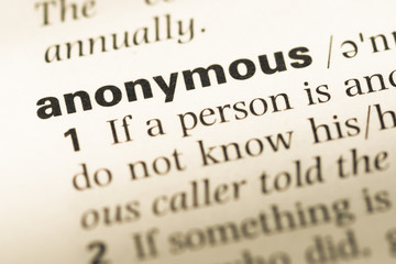 Obraz premium Close up of old English dictionary page with word anonymous
