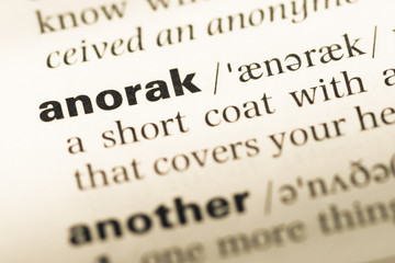 Obraz premium Close up of old English dictionary page with word anorak