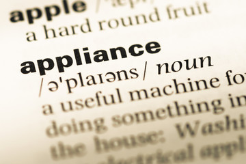 Obraz premium Close up of old English dictionary page with word appliance