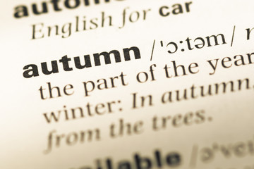 Close up of old English dictionary page with word autumn