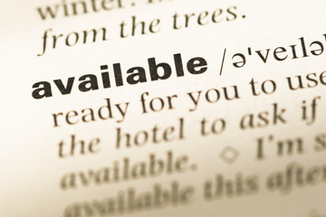 Obraz premium Close up of old English dictionary page with word available