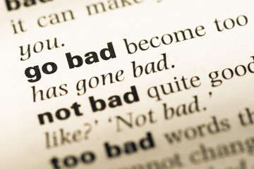 Obraz premium Close up of old English dictionary page with word go bad