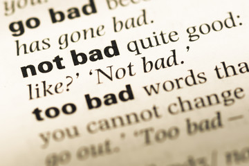 Obraz premium Close up of old English dictionary page with word not bad