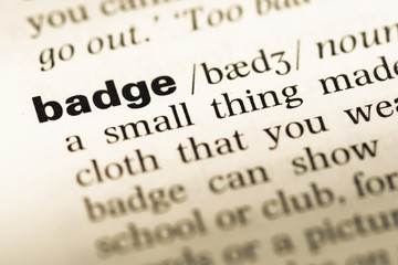 Obraz premium Close up of old English dictionary page with word badge