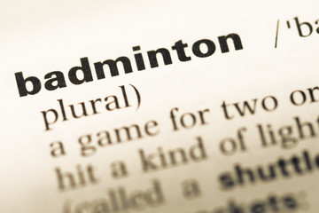 Close up of old English dictionary page with word badminton