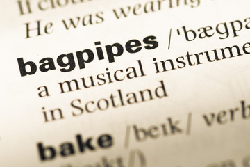 Obraz premium Close up of old English dictionary page with word bagpipes
