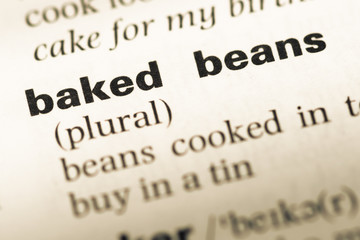 Close up of old English dictionary page with word baked beans