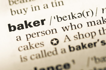Obraz premium Close up of old English dictionary page with word baker