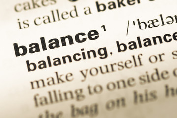 Obraz premium Close up of old English dictionary page with word balance