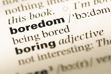Obraz premium Close up of old English dictionary page with word boredom