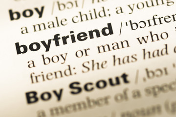 Obraz premium Close up of old English dictionary page with word boyfriend