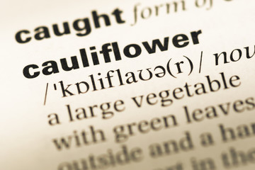 Obraz premium Close up of old English dictionary page with word cauliflower