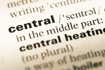 Close up of old English dictionary page with word central