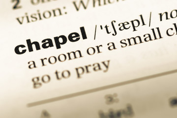 Obraz premium Close up of old English dictionary page with word chapel