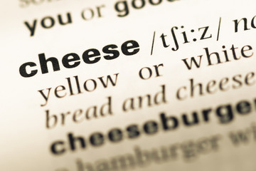 Close up of old English dictionary page with word cheese