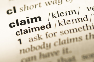 Obraz premium Close up of old English dictionary page with word claim