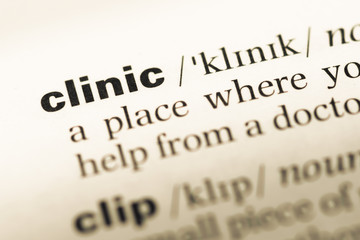 Obraz premium Close up of old English dictionary page with word clinic