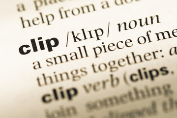 Obraz premium Close up of old English dictionary page with word clip